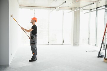 Male workers doing interior renovation in apartment.