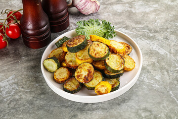 Roasted young zucchini in the plate