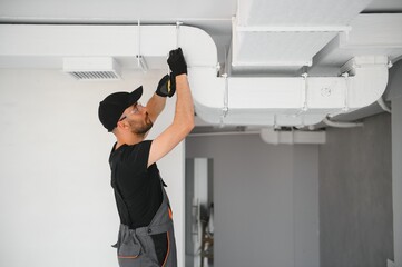 hvac services, worker install ducted pipe system for ventilation and air conditioning in house