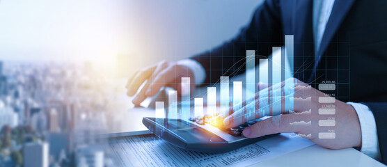 Businessman using the laptop computer and calculator tax online return form for payment, Accounting financial research, government taxes and calculation tax return concept.
