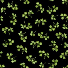 Seamless pattern of hand drawn clovers on black background, marker illustration. For wallpapers, wrapping paper, fabric, textile, product packaging, polygraphy covers, Saint Patrick's Day decorations