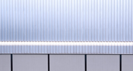 Aluminium corrugated steel and gray concrete wall with awning eaves of large modern industrial factory building in minimal style