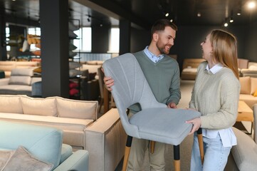 Obraz premium Happy couple choosing furniture in store