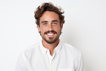 Obraz premium Portrait of a handsome young man smiling while standing against white background