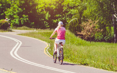 Fototapeta premium Cyclist ride on the bike path in the city Park 