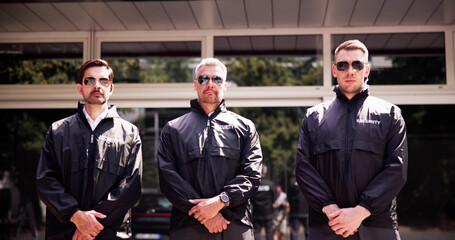 Professional Security Guard Ensuring Event Safety with His Team of Bodyguards