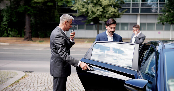 Corporate Bodyguards assure a safe exit for businessman in luxury vehicle