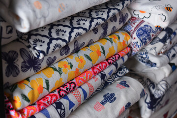 Fototapeta premium heap of colorful cloth on shelf for sale in store