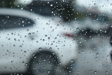 water drop on mirror in defocused car parking background