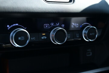 interior view of car with black leather, closeup car air conditional control