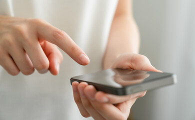 Hand holding smartphone with using social media.