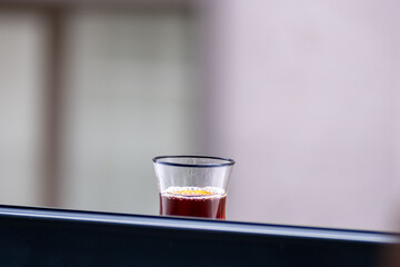 A glass of Turkish tea in front of the window