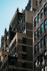 Architectural details of a brick building in New York City under a clear sky