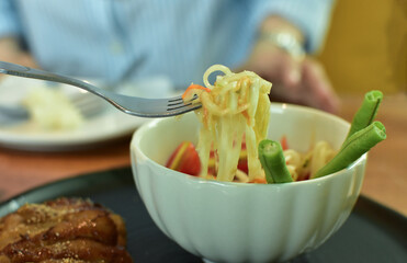At Somtam restaurant, there is sticky rice and grilled pork on the plate.