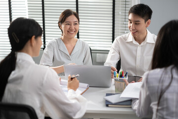 Fototapeta premium Asian Man and woman co-worker consult about work or team meeting at work with serious emotion.