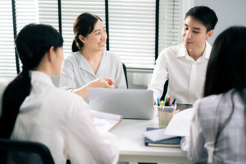 Asian Man and woman co-worker consult about work or team meeting at work with serious emotion.