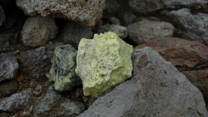 Close-up of sulfur rocks with a rough textured surface.