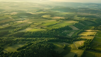 Fototapeta premium Stunning aerial view from airplane window, capturing verdant forests and open fields