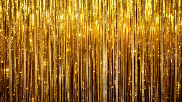 Luxurious shimmering gold tinsel curtain drapes elegantly, creating a wide, glamorous party background with a foil fringe disco-inspired ambiance.