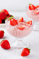 Vegan yogurt, whipped tofu and strawberry dessert in a glass. Lactose and sugar free. Vertical orientation.