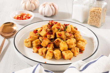 Tahu Cabe Garam or Salt and Pepper Tofu, Crispy Cubed Deep Fried Tofu with Garlic and Chilli Flakes. Perfect for recipe, article, or any cooking contents.