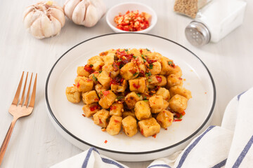 Tahu Cabe Garam or Salt and Pepper Tofu, Crispy Cubed Deep Fried Tofu with Garlic and Chilli Flakes. Perfect for recipe, article, or any cooking contents.