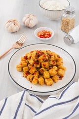Tahu Cabe Garam or Salt and Pepper Tofu, Crispy Cubed Deep Fried Tofu with Garlic and Chilli Flakes. Perfect for recipe, article, or any cooking contents.