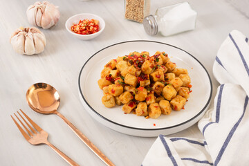 Tahu Cabe Garam or Salt and Pepper Tofu, Crispy Cubed Deep Fried Tofu with Garlic and Chilli Flakes. Perfect for recipe, article, or any cooking contents.