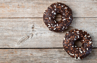 Set of colorful donuts on wooden background