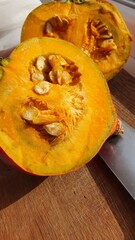 Sliced pumpkin in half on a cutting board