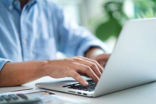 Businessman's hands are managing data on a computer. Make reports with KPIs and indicators connected to the database. Corporate strategy for finance, sales, marketing