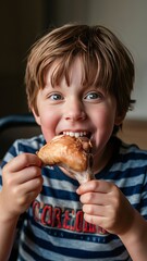 A boy is eating a fried chicken leg with gusto.