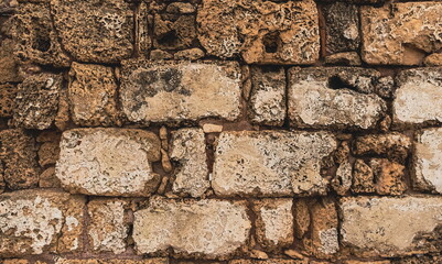 Ancient Weathered Stone Wall Texture Close-Up Sepia