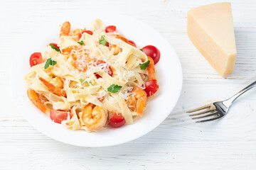 Italian pasta with shrimps , parmesan and tomatoes