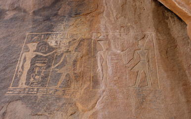 Ancient egyptian carvings and hieroglyphs on granite rocks near Famine Stela in Aswan, Egypt 