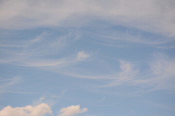 Blue sky with white delicate clouds. Background