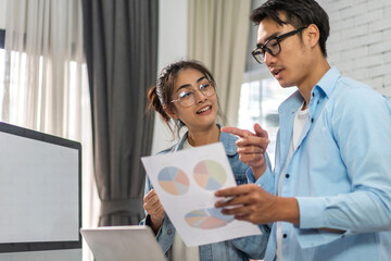 Young asian couple relaxing using laptop computer work and video conference meeting online chat.Creative business couple planning strategy analysis and brainstorm at home