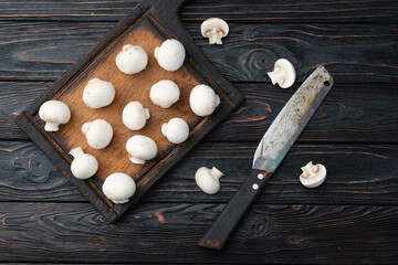 Many raw mushroom champignon  on wooden background