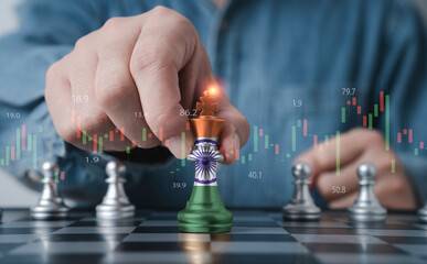 Businessman holding India flag which print screen on king chess for India country is leadership for economic growth and financial investment of South Asia concept.