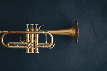Obraz premium Elegant Antique Brass Trumpet on Dark Velvet Background with Soft Ambient Light Reflections
