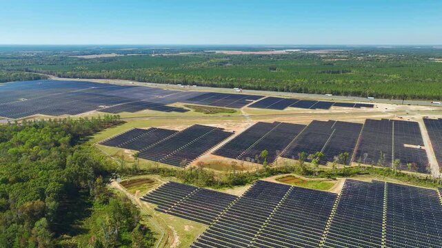 Big sustainable electric power plant with many rows of solar photovoltaic panels for producing clean electrical energy. Renewable electricity with zero emission concept