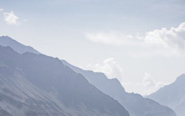 Silhouette of Tien Shan rocky mountain range against cloudy sky in Pamir in Tajikistan mountains, minimalistic abstract landscape of mountains for background