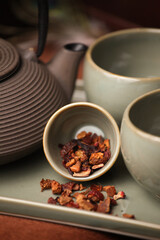 tea leaves with Japanese tea pot close up