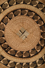 Traditional South African woven basket with geometric paterns.