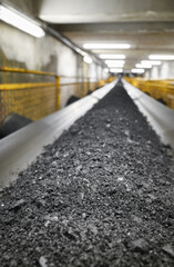 Belt conveyor transporting coal in a heating plant, selective focusing.