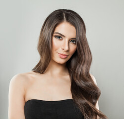 Cheerful young adult model woman with long healthy hairstyle, fresh shiny clear skin and makeup...