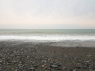 Gray nature background. Empty beach and sea