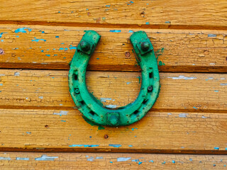 Old horseshoe on the door as symbol of luck