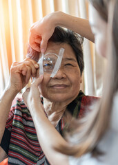 Cataract elderly patient, Asian old senior woman having eye care treatment on Age-related eye...