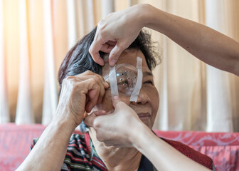 Cataract elderly patient, Asian old senior woman having eye care treatment on Age-related eye...